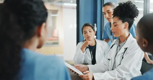 Medical professionals discussing retirement planning strategies in a hospital meeting
