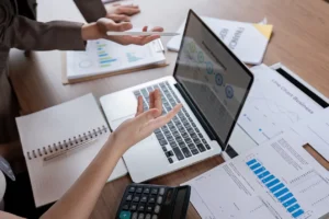 Advisor from Hilltop Wealth & Tax Solutions discussing financial planning strategies with a small business owner